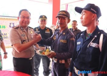 Kapolres Karimun Yos Guntur Yudi FS saat memberikan kue tumpeng kepada salah satu satpam
